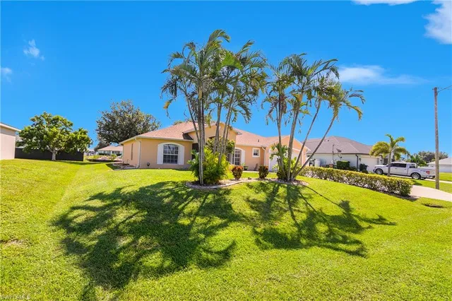 a view of an house with backyard space and garden