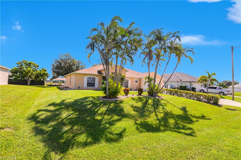 2905 Northeast 1st Place Cape Coral, FL 33909 - Photo 29 of 32 a view of a house with a yard
