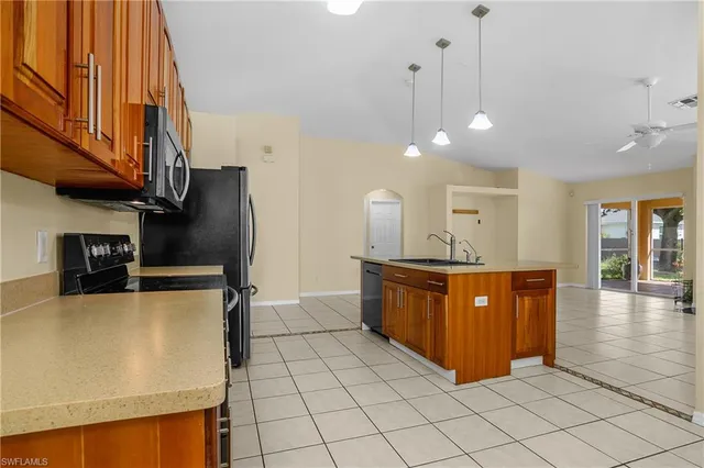 a kitchen with stainless steel appliances granite countertop a refrigerator and a sink