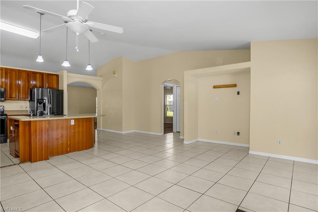 2905 Northeast 1st Place Cape Coral, FL 33909 - Photo 31 of 32 a view of kitchen with refrigerator cabinets and outdoor space