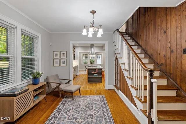 a living room with furniture and a chandelier