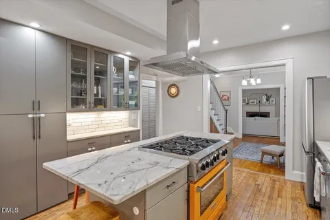 a kitchen that has a stove and a table