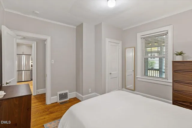 a bedroom with a bed and a window