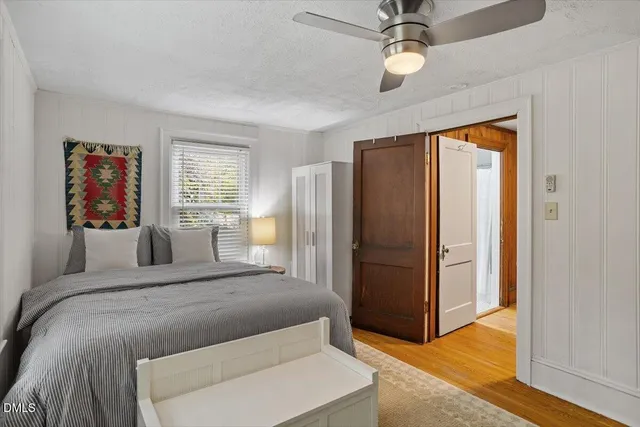 a bedroom with a large bed and a chandelier