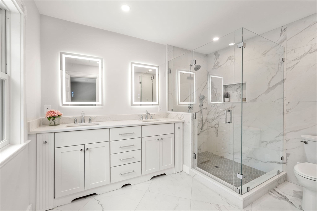 63 Griggs Road Brookline, MA 02446 - Photo 11 of 20 a bathroom with a shower sink mirror and toilet