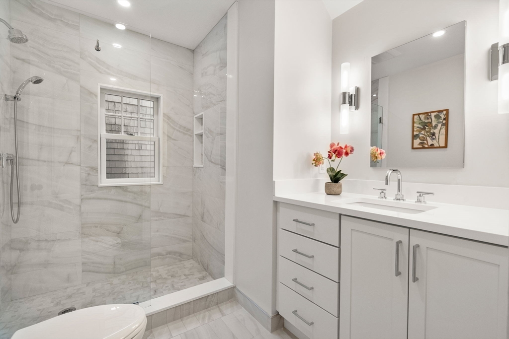 63 Griggs Road Brookline, MA 02446 - Photo 13 of 20 a bathroom with a sink shower and a mirror