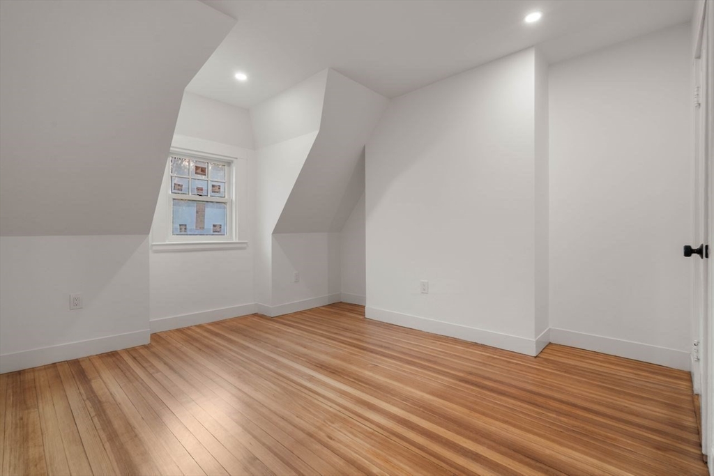 63 Griggs Road Brookline, MA 02446 - Photo 14 of 20 wooden floor in an empty room with a window