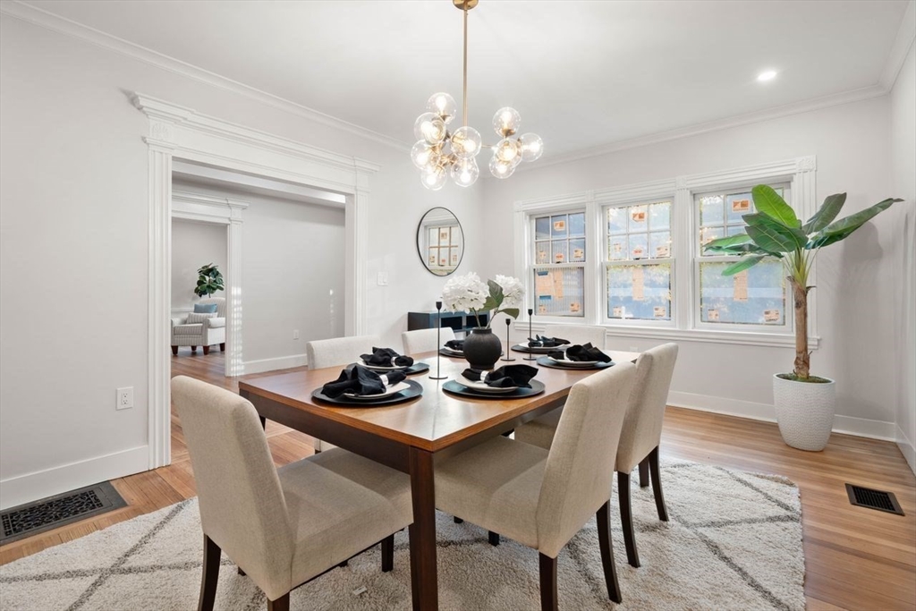 63 Griggs Road Brookline, MA 02446 - Photo 6 of 20 a dining room with furniture a chandelier and wooden floor