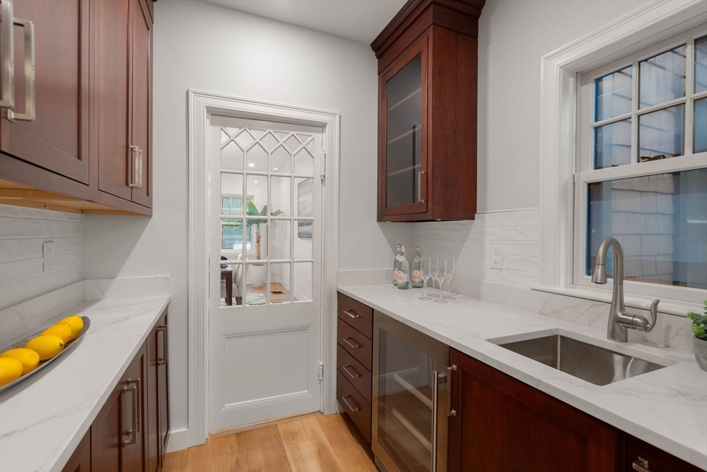 63 Griggs Road Brookline, MA 02446 - Photo 7 of 20 a kitchen with a sink cabinets and a wooden floor