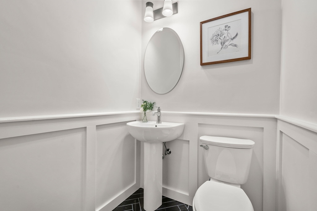63 Griggs Road Brookline, MA 02446 - Photo 8 of 20 a bathroom with a toilet a sink and mirror