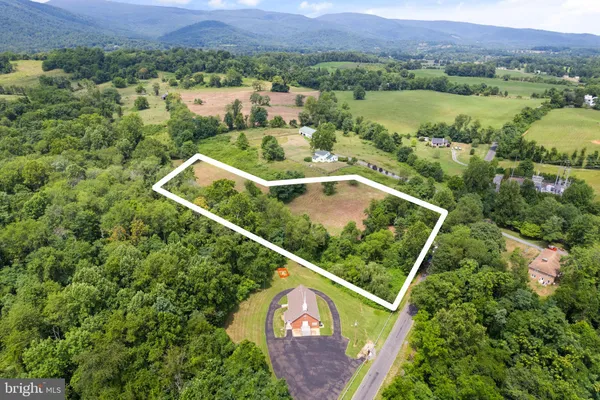 an aerial view of residential house with outdoor space and street view