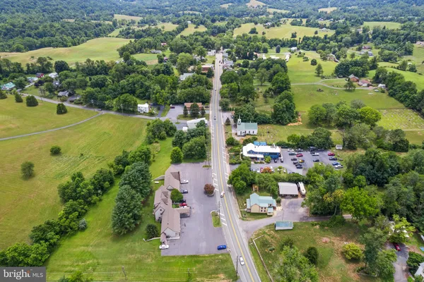 an aerial view of a houses with a yard
