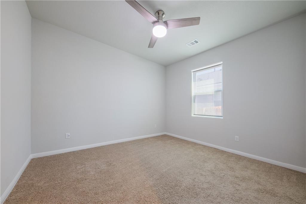 204 Cold Spg Loop Bastrop, TX 78602 - Photo 11 of 34 Neutral wall tones and beige carpeting create a versatile interior