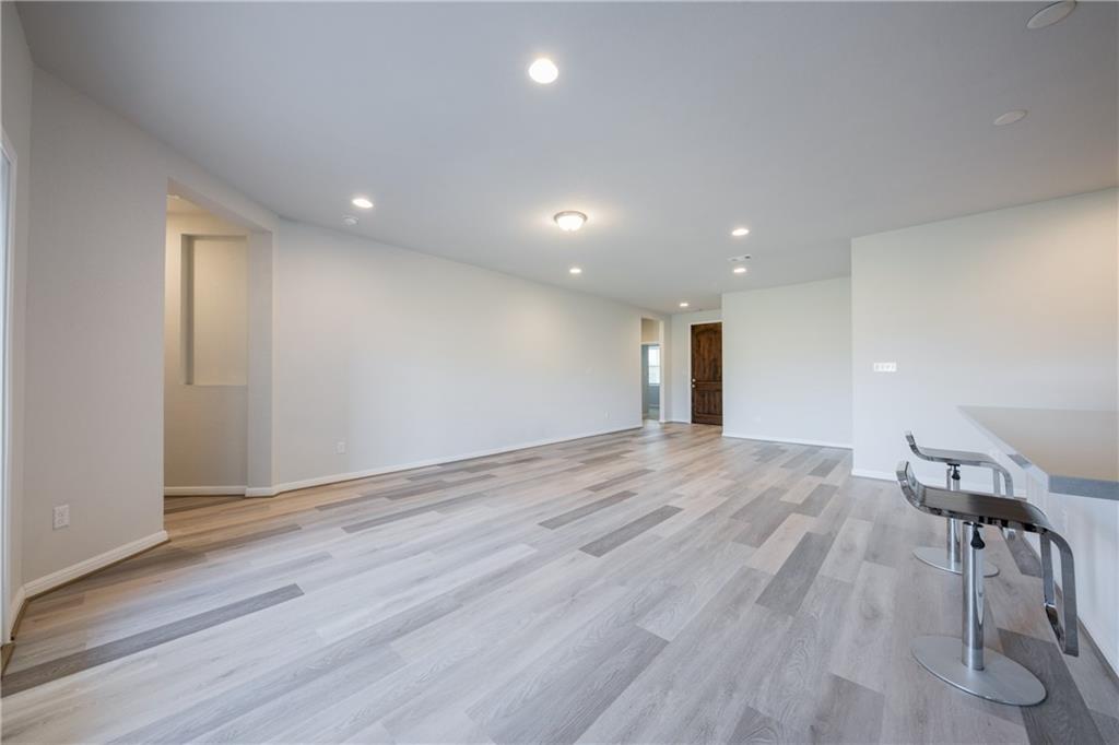 204 Cold Spg Loop Bastrop, TX 78602 - Photo 18 of 34 Spacious interior featuring wood-finish flooring, recessed lighting, and a neutral color palette