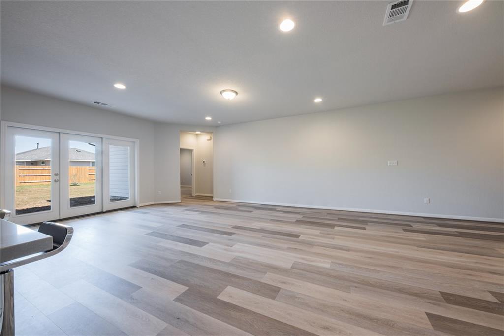 204 Cold Spg Loop Bastrop, TX 78602 - Photo 28 of 34 Spacious living area featuring wood-finish flooring, recessed lighting, and a neutral wall palette