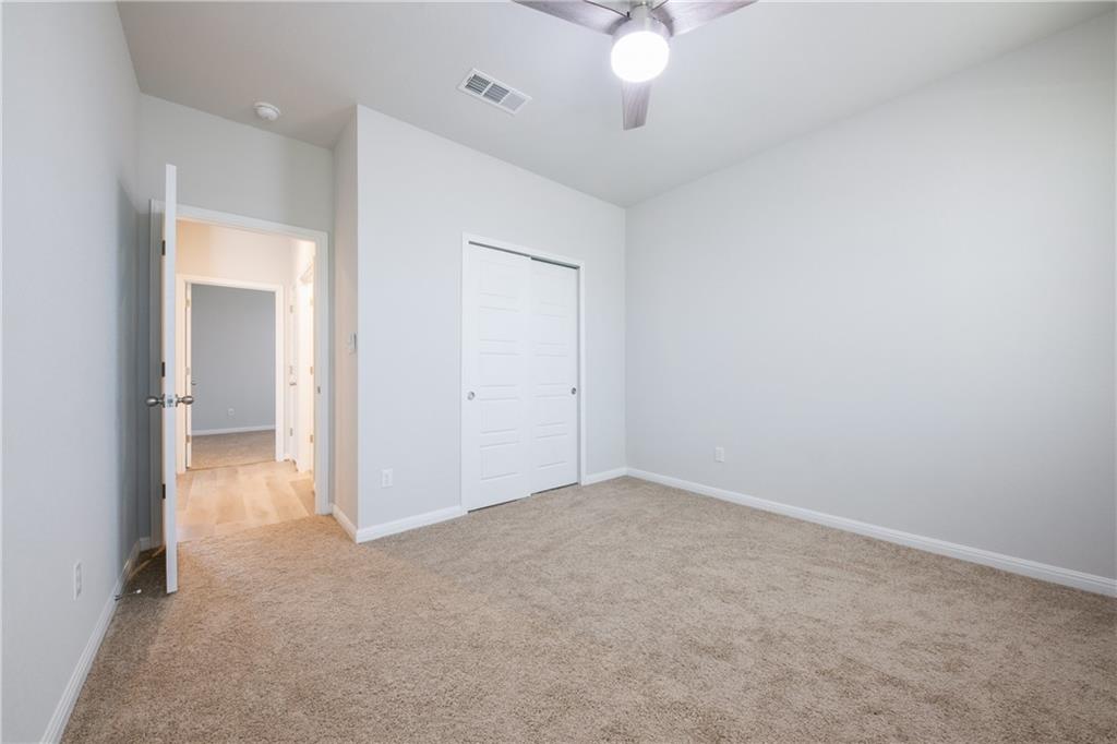 204 Cold Spg Loop Bastrop, TX 78602 - Photo 31 of 34 Bedroom featuring neutral-toned carpet flooring and light gray painted walls