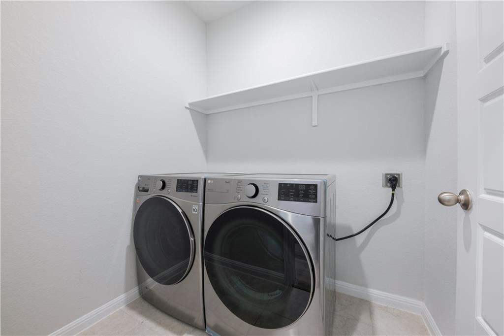 204 Cold Spg Loop Bastrop, TX 78602 - Photo 34 of 34 Dedicated laundry area featuring a white wall shelf, light gray wall paint, and baseboard trim
