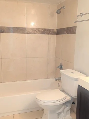 a bathroom with a toilet a sink and a shower