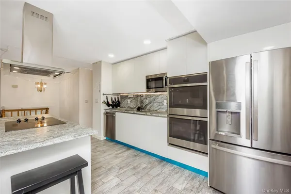 a kitchen with a refrigerator and a sink