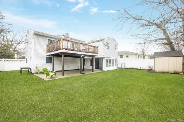 a view of an house with backyard and sitting area