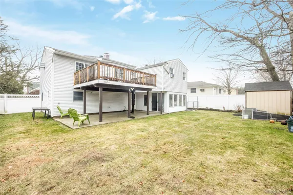 a view of an house with backyard and tree
