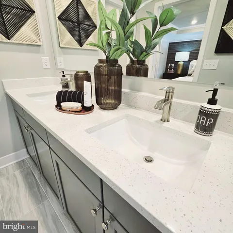 a bathroom with a sink a vanity and mirror