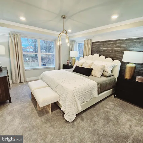 a spacious bedroom with a bed a window and walk in closet