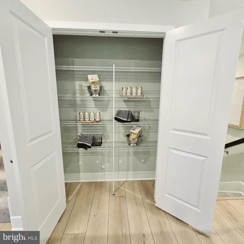 a bedroom with a bed lamp and a large window