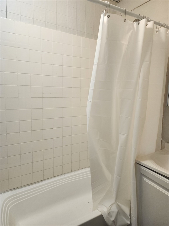141 Franklin Street, Unit 2 Lynn, MA 01902 - Photo 6 of 6 a bathroom with a shower and a bathtub