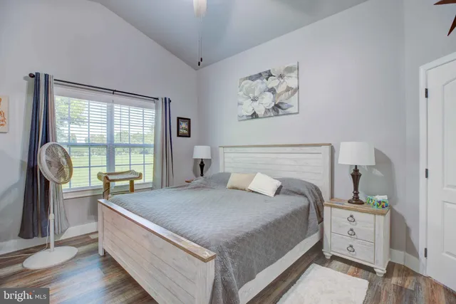 a bedroom with a bed and a large window