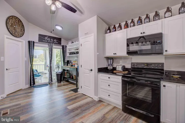 a kitchen with stainless steel appliances granite countertop a stove and cabinets