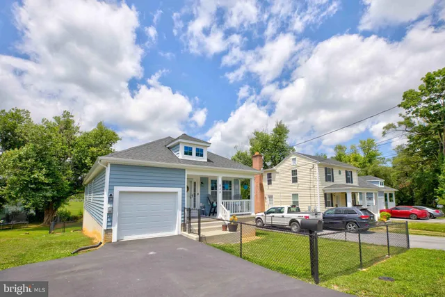 a front view of house with yard and outdoor seating