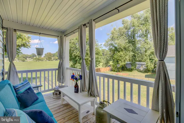 a balcony with furniture and a potted plant