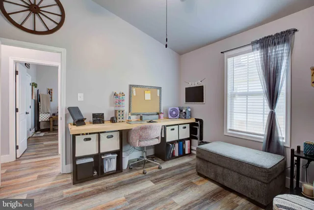 a living room with furniture a window and a flat screen tv