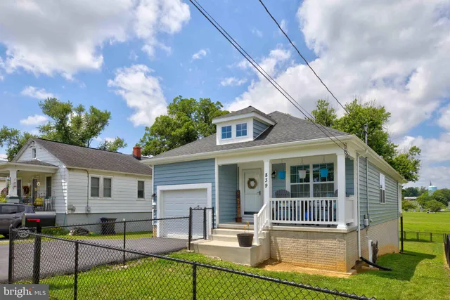 a front view of house with yard and green space