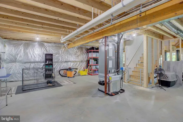 a view of an empty room with wooden floor and door