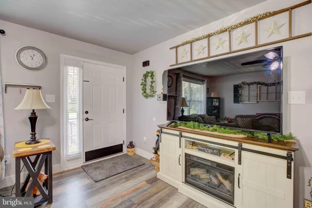 a kitchen with stainless steel appliances granite countertop a stove and a wooden floors