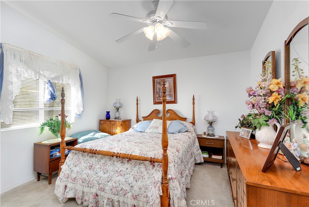 29520 Piani Road Pearblossom, CA 93553 - Photo 16 of 34 a bed room with furniture and a chandelier