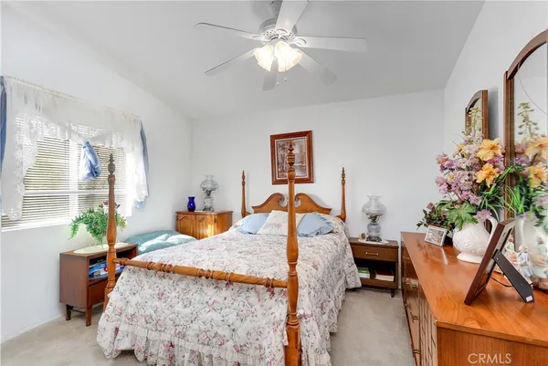 a kitchen with stainless steel appliances granite countertop a sink dishwasher stove and refrigerator with wooden cabinets