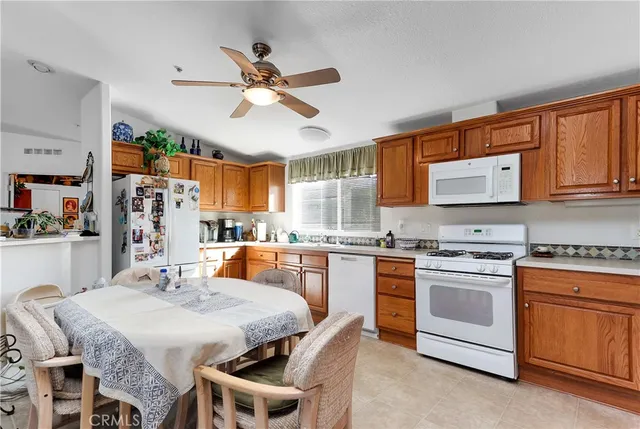 a kitchen with stainless steel appliances granite countertop a stove a sink dishwasher and a refrigerator