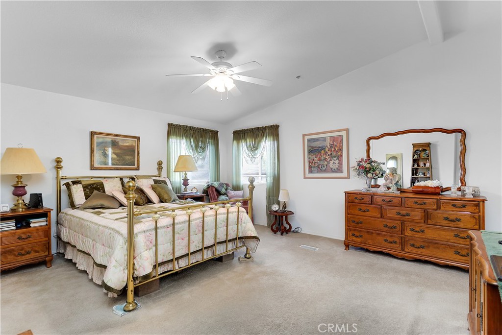 29520 Piani Road Pearblossom, CA 93553 - Photo 28 of 34 a bedroom with a bed and a chandelier