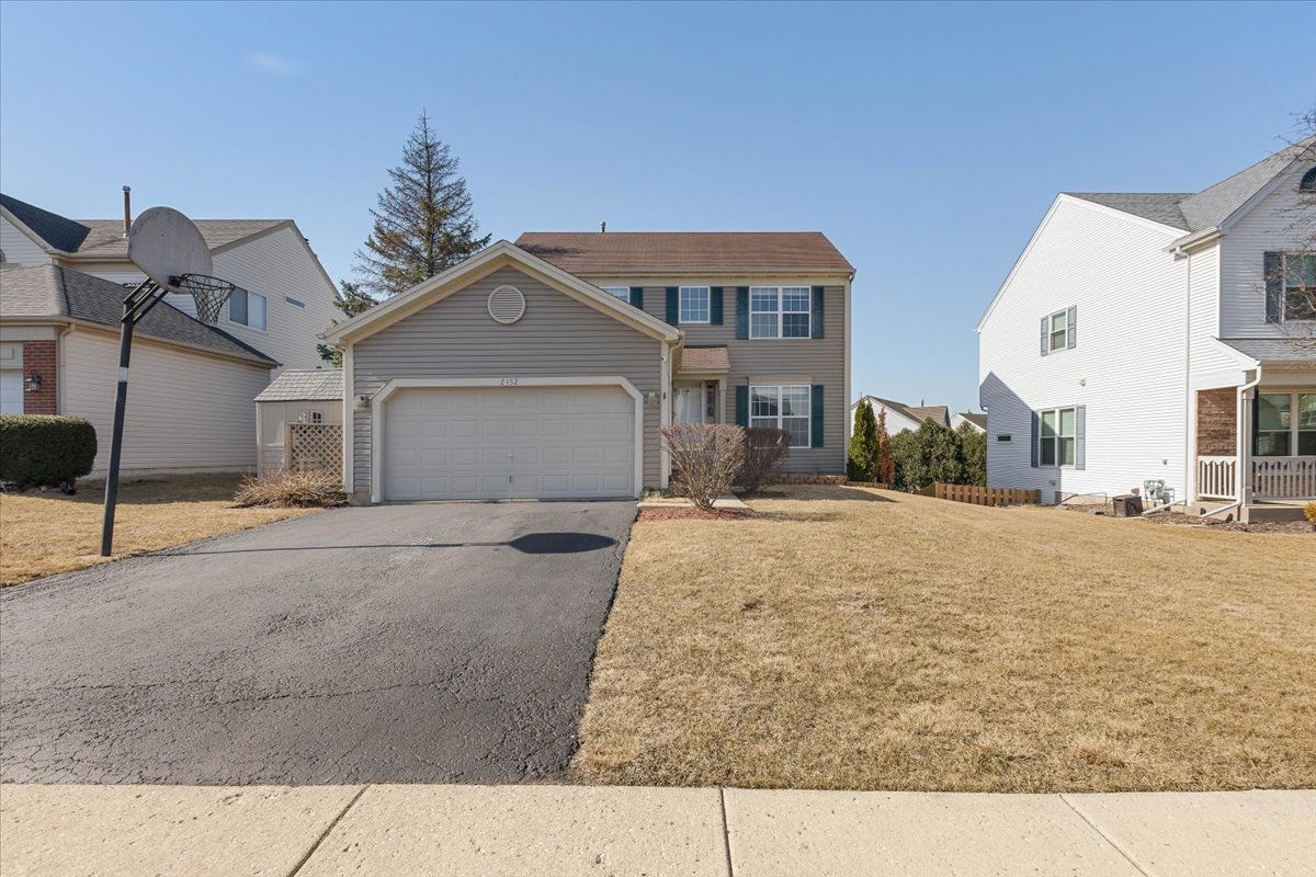 2152 North Green Valley Lane Round Lake Beach, IL 60073 - Photo 1 of 1 a front view of a house with a yard and garage