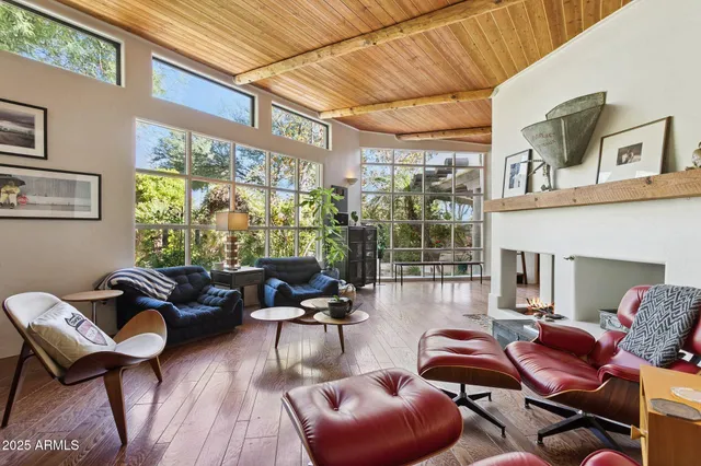 a living room filled with furniture and a floor to ceiling window