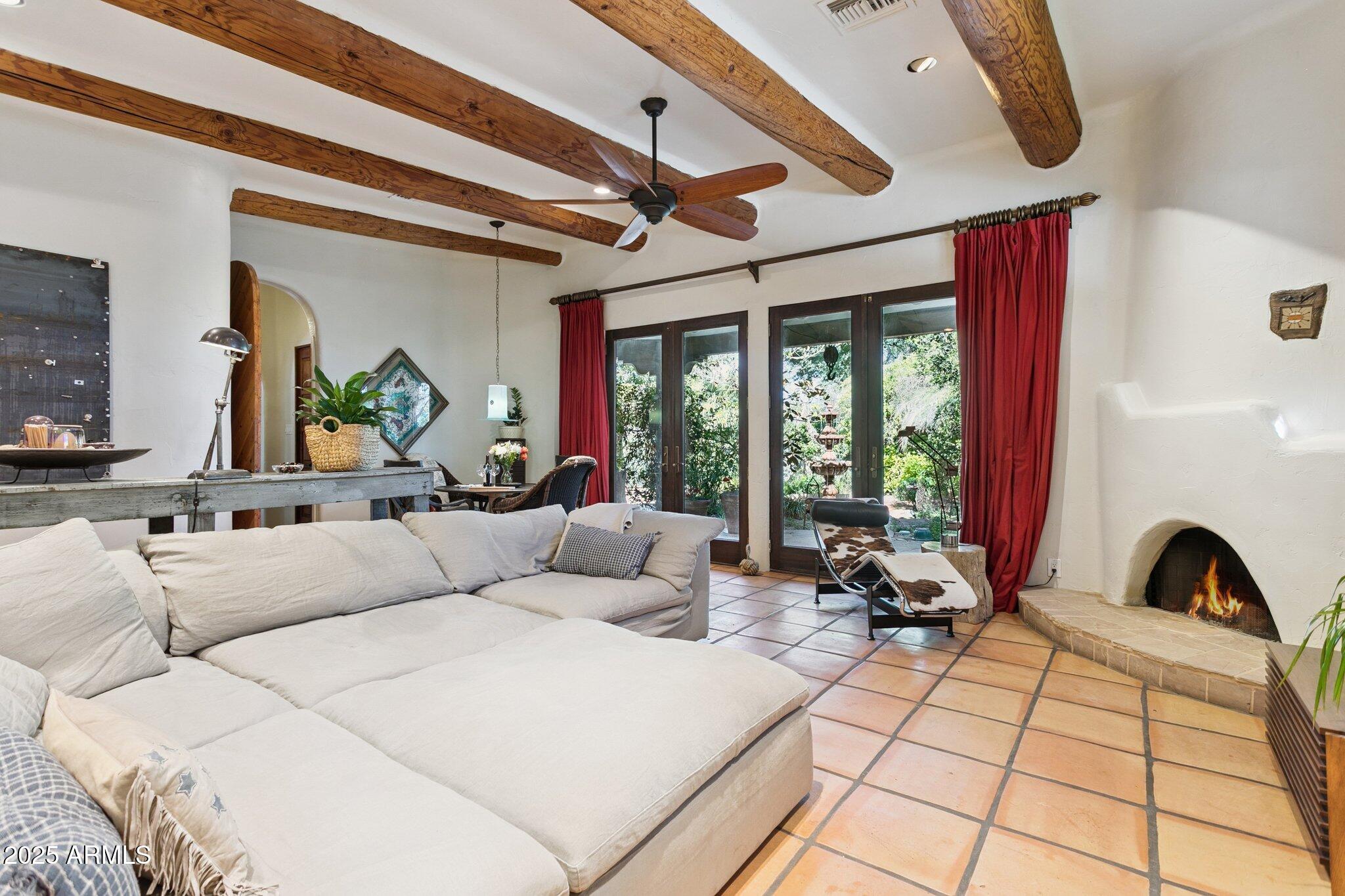 7005 East Jackrabbit Road Paradise Valley, AZ 85253 - Photo 13 of 61 a living room with furniture fireplace and large windows