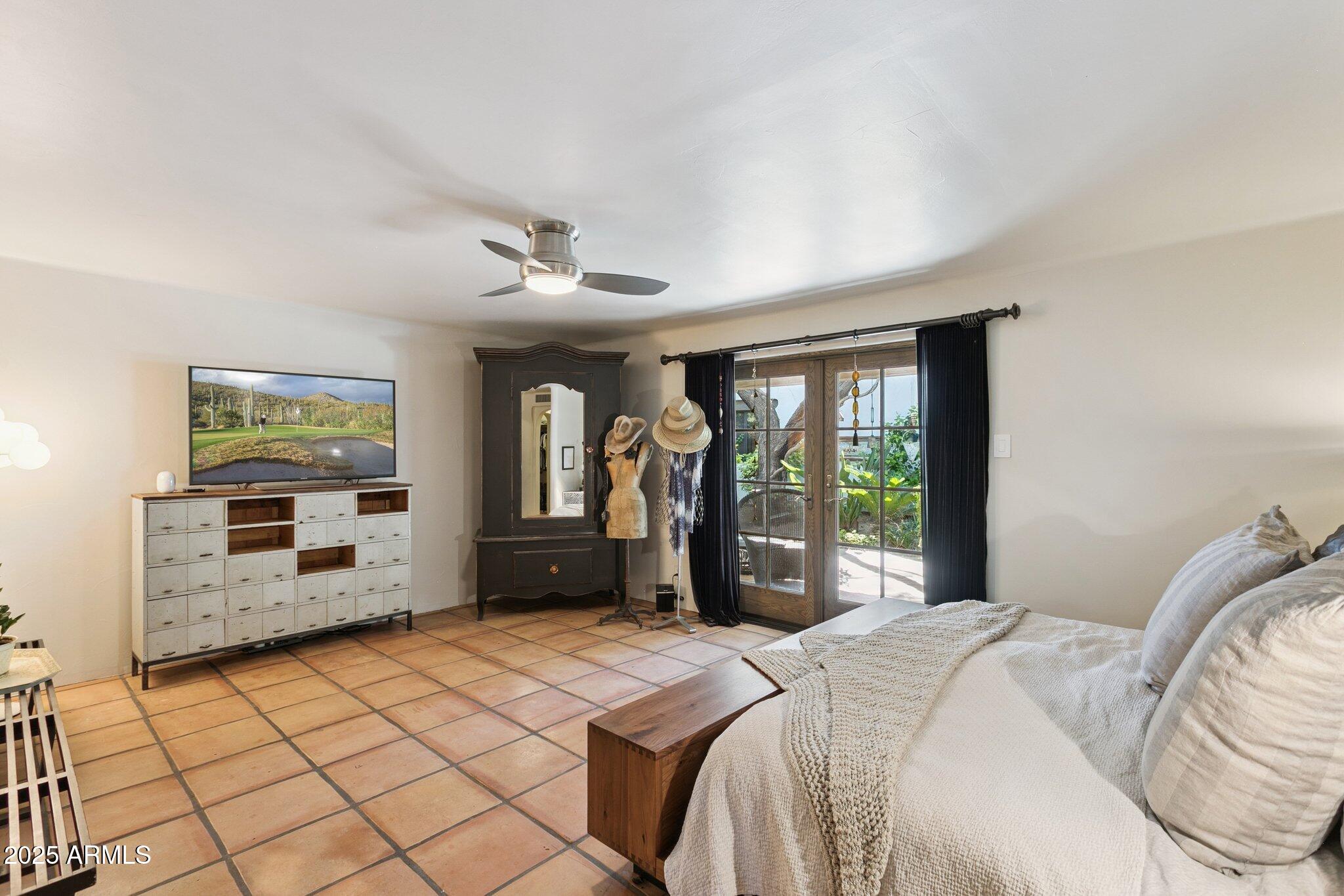 7005 East Jackrabbit Road Paradise Valley, AZ 85253 - Photo 23 of 61 a bedroom with a bed and a large window