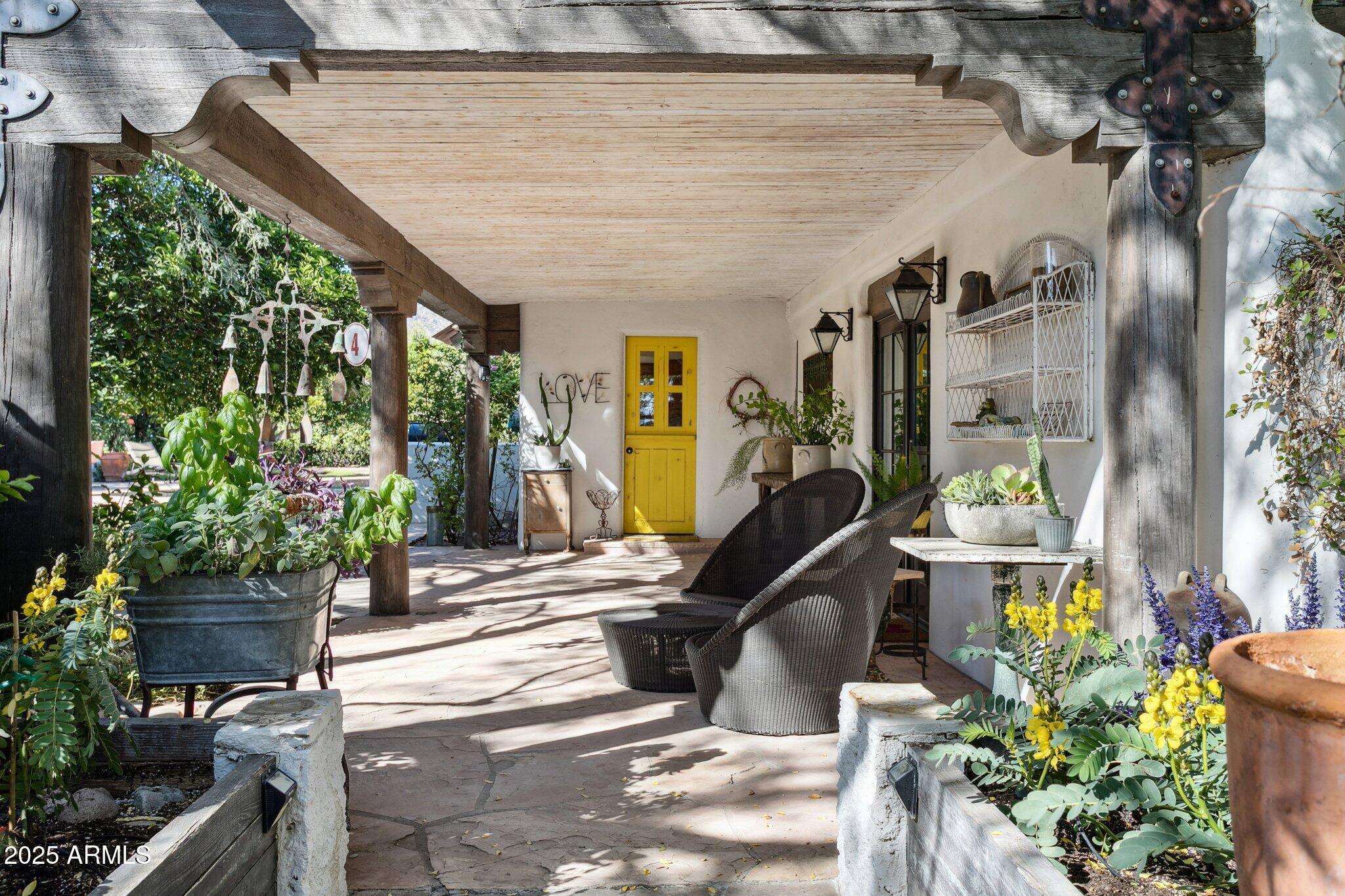 7005 East Jackrabbit Road Paradise Valley, AZ 85253 - Photo 25 of 61 a view of a porch with potted plants