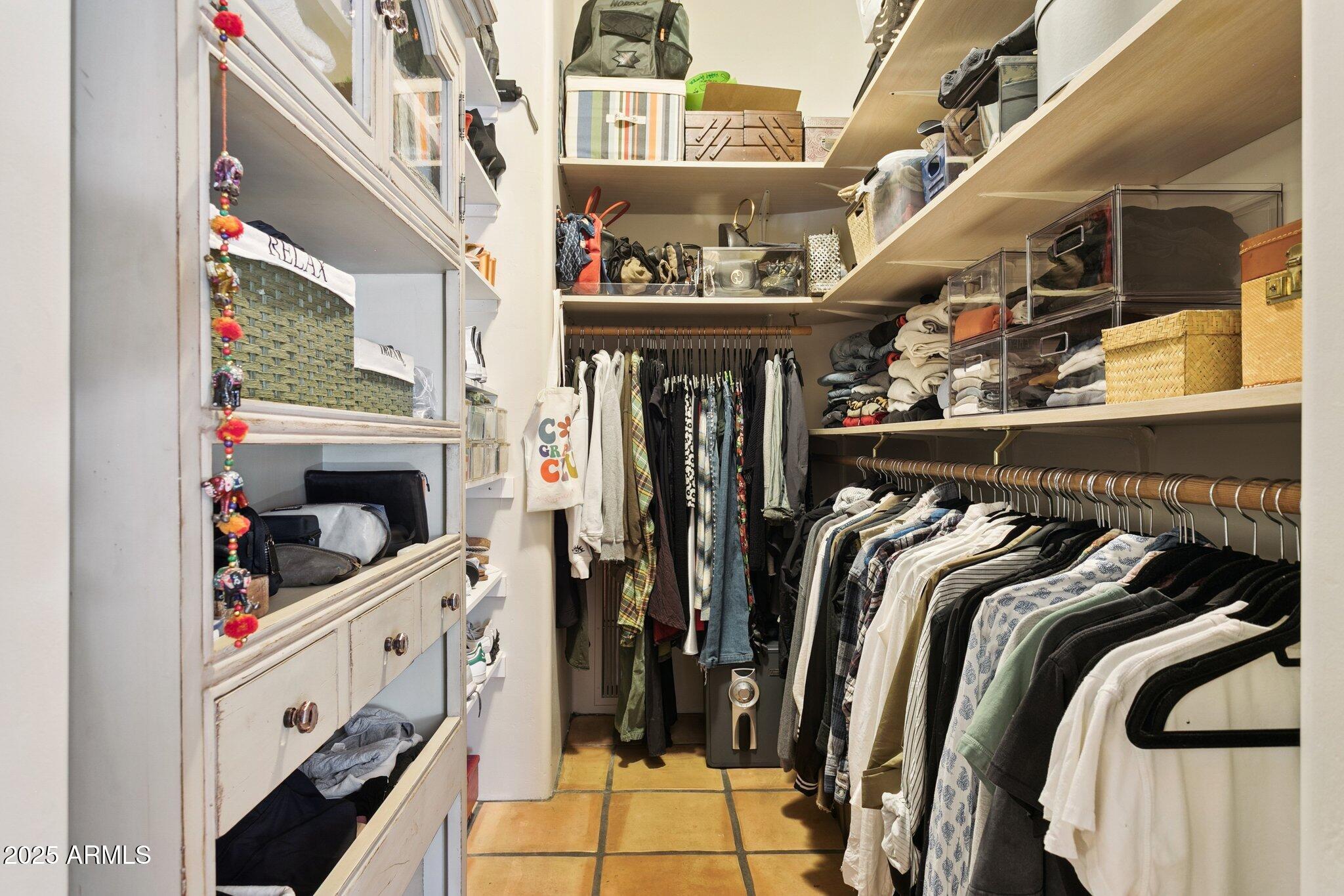 7005 East Jackrabbit Road Paradise Valley, AZ 85253 - Photo 28 of 61 a view of walk in closet with clothes and shoes