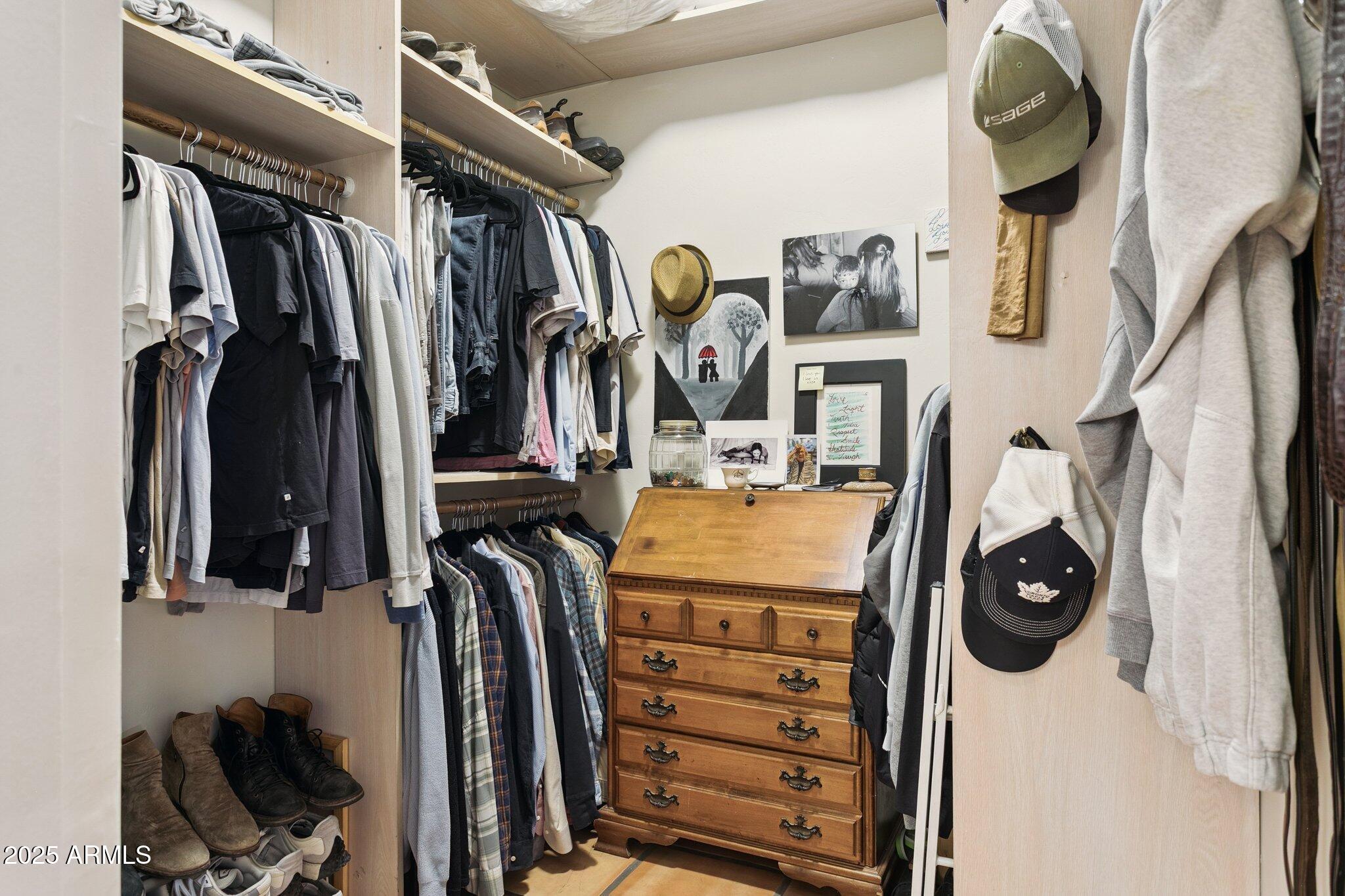 7005 East Jackrabbit Road Paradise Valley, AZ 85253 - Photo 29 of 61 a view of walk in closet with clothes and shoes