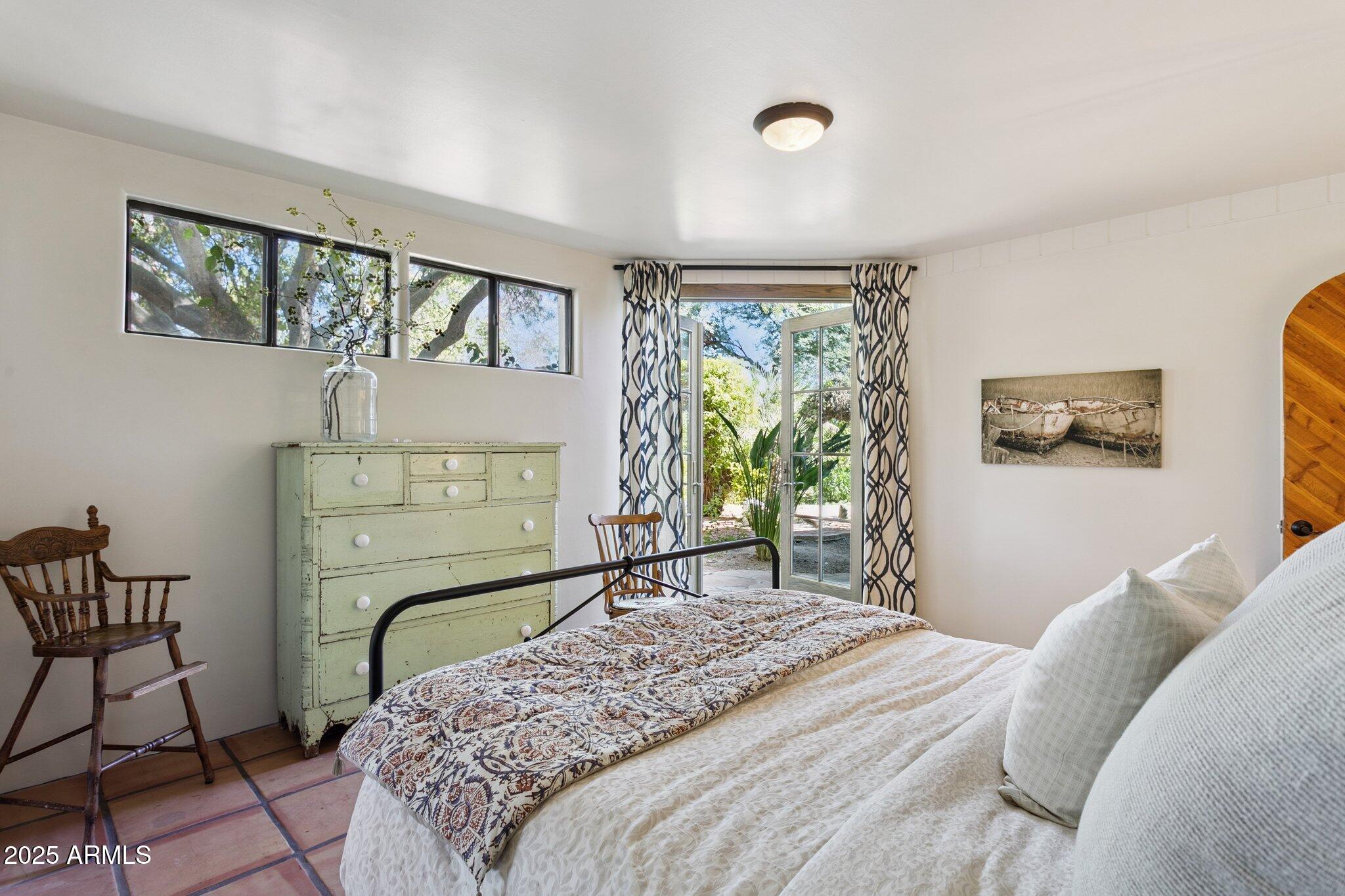 7005 East Jackrabbit Road Paradise Valley, AZ 85253 - Photo 30 of 61 a bedroom with a bed couch and a window