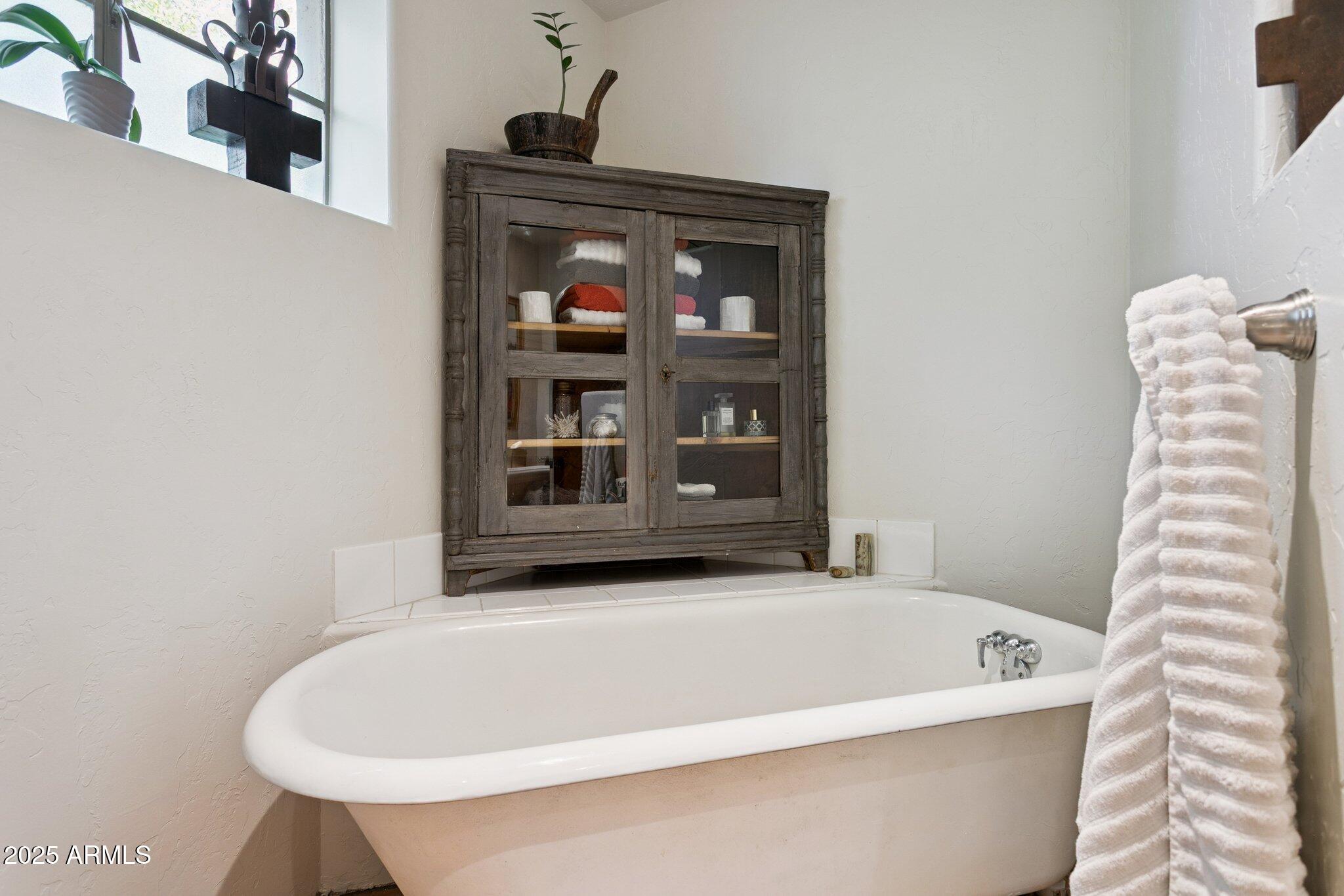 7005 East Jackrabbit Road Paradise Valley, AZ 85253 - Photo 35 of 61 a white bath tub sitting in a bathroom